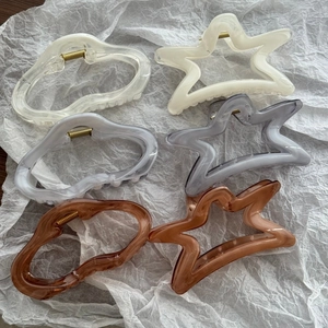 Set of six two-tone star and cloud-shaped acetate hair claws with marble patterns