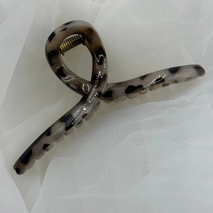Detailed macro view of large leopard print hair claw clip with strong metal spring