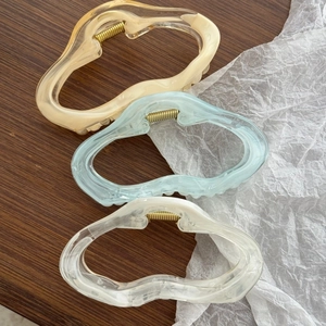 Three-piece set of large acrylic star hair claws in amber, light blue, and transparent white