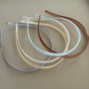 Detail of five translucent minimalist headbands with non-slip teeth and glossy finish