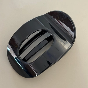 Detailed view of the glossy black oval hollow hair claw clip with smooth resin finish