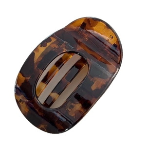 Classic tortoise shell hair claw clip with hollow oval design and amber pattern