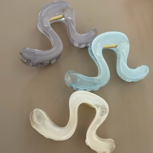 Three elegant large wavy hair claw clips in Morandi colors for stylish hair styling