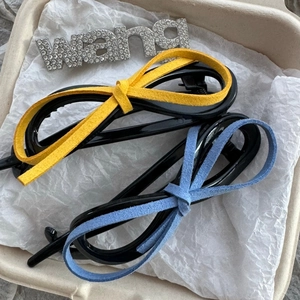 Leopard print leather bow twist hair clips in bright yellow and misty blue colors