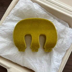 Detail of mustard yellow velvet shark hair clip in an eco-friendly gift box packaging
