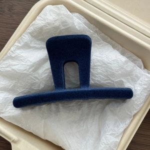 Detail view of navy blue velvet flocking shark clip in M-shaped minimalist arch design