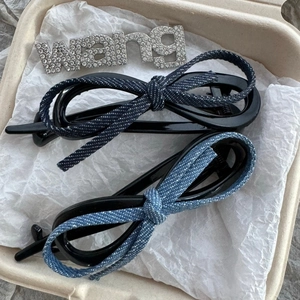 Denim bow hair clips with crystal letter embellishments in light and dark blue wash