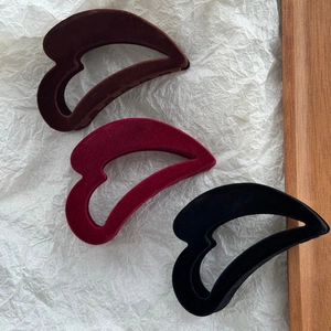 Détail des pinces à cheveux coeur floquées en marron foncé, bordeaux et noir velours