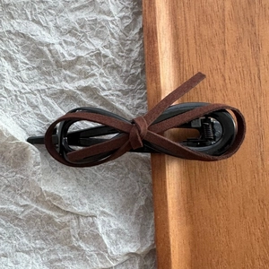 Detail of leopard print suede bow hair clip on premium black metal duckbill base