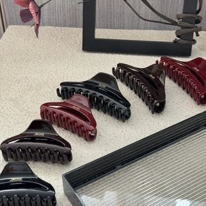 French style hair claw clips in various colors with elegant golden lettering detail