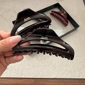 Large dark brown crescent hair claw clip for women featuring Barrette LaFrance gold lettering