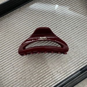 Detail view of burgundy moon hair claw clip with golden Barrette la France lettering