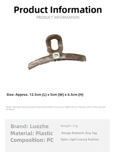 Detail showing marble texture large hair claw clip with golden dog motif and size info