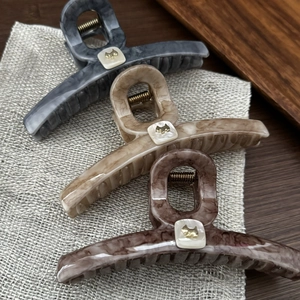 Three large tortoiseshell claw clips with cute dog accents for elegant hair styling
