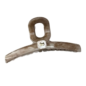 Elegant tortoiseshell claw clip with gold puppy logo on a white square pearlescent accent