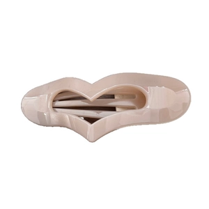 Minimalist beige hollow heart hair claw clip with a glossy finish on white background