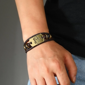 Detail of multi-layer brown leather bracelet with bronze lion head and retro beads