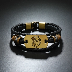 Detail of braided leather bracelet featuring a leopard head metal plate and push buckle