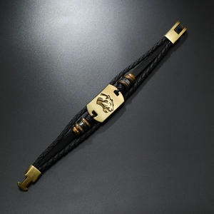 Macro detail of men's leather bracelet featuring a vintage leopard head alloy plate