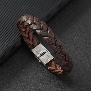 Detail of dark brown braided leather bracelet featuring a polished stainless steel clasp