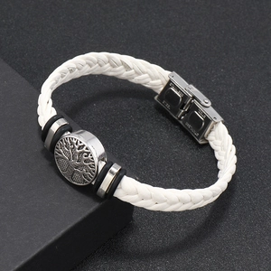 Detail view of white braided leather bracelet with stainless steel tree of life clasp