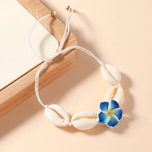 Detail view of Bohemian woven anklet with white shells and Frangipani flower decoration