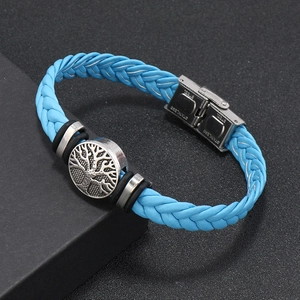 Close-up of light blue braided leather bracelet with silver tree of life charm and steel clasp