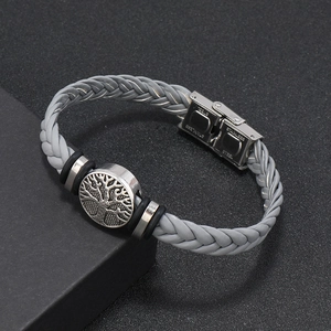 Close-up of stainless steel clasp and gray braided tree of life bracelet detail