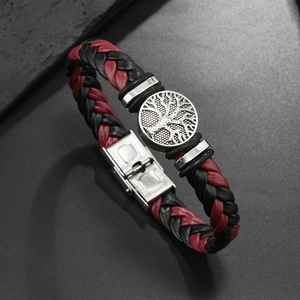 Detailed macro view of woven red and black leather bracelet with tree of life steel clasp