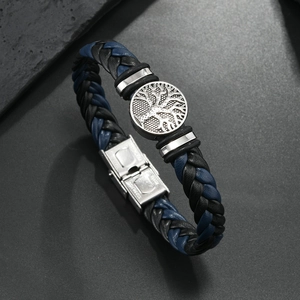 Detail of braided leather bracelet with silver tree of life charm and steel clasp
