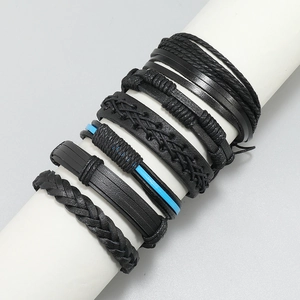 Detail view of 6-piece multilayer black braided leather bracelets with various textures