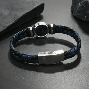 Detailed view of men's blue and black braided leather bracelet with stainless steel clasp