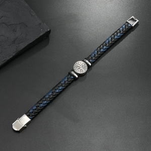 Detail of men's leather bracelet with silver tree of life charm and metal buckle