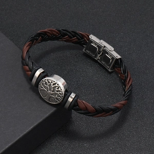 Detailed macro view of stainless steel clasp and engraved tree of life leather bracelet