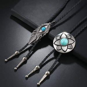 Vintage western turquoise bolo ties featuring silver feather and floral pendants