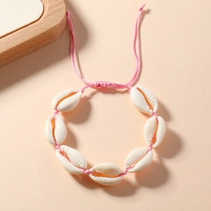 Detail of pink handmade woven shell bracelet with adjustable drawstring closure