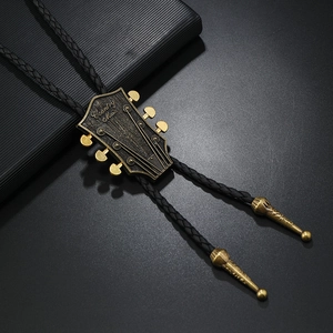Dettaglio del bolo tie a forma di chitarra in bronzo con incisione Country Music e corda