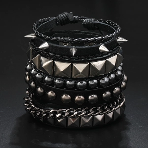 Detailed close-up of multilayer punk bracelet set featuring leather and metal spikes