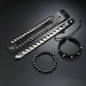 Detailed close-up of multilayer punk chain bracelets with leather studs and beads