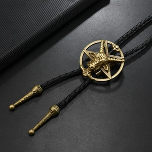 Detail of vintage bronze Baphomet goat head bolo tie with black braided leather rope
