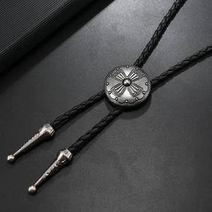 Vintage western bolo tie with silver cross relief sliding buckle and black leather cord