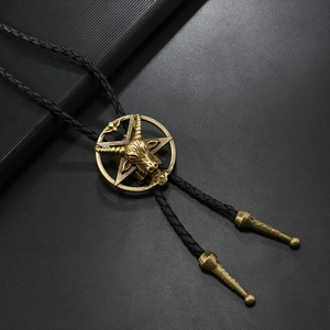 Macro view of vintage bronze goat head pentagram bolo tie with black braided leather cord