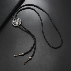 Vintage silver sunflower bolo tie with black braided leather rope and engraved metal tips