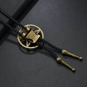 Macro detail of bronze star medallion and woven leather cord on a vintage bolo tie