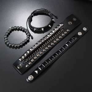 Detail of four-piece punk layered chain bracelet set with leather and metal studs