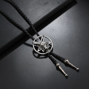 Macro shot of silver Baphomet goat head pentagram pendant on black braided bolo tie
