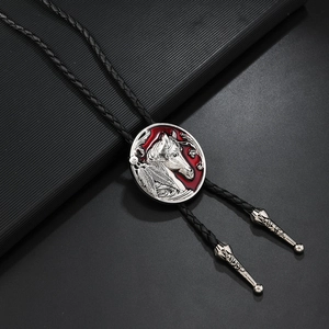 Vintage Western Bolo Tie mit Pferdekopf-Relief auf rotem Hintergrund und geflochtener Kordel