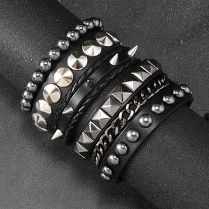 Detail view of multi-layer punk bracelet set with silver studs, chains and black leather