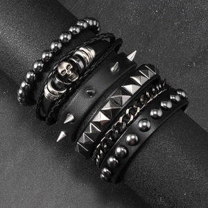 Macro detail of multi-layer punk leather bracelet set with studs and skulls on display