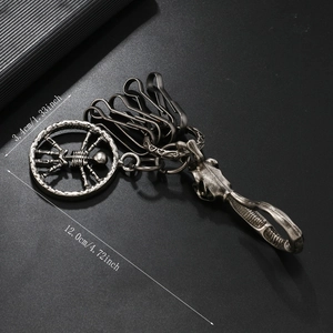Detail view of gothic skeleton metal keychain with dimensions of 3.4cm diameter and 12cm length